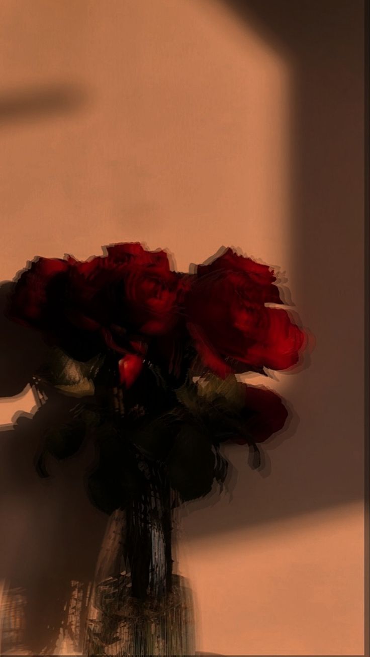 A vase of deep red roses in warm, dreamy light